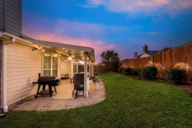 yard at dusk with a patio area