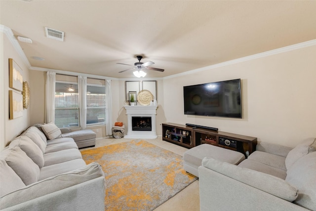 carpeted living room with crown molding, a fireplace, and ceiling fan