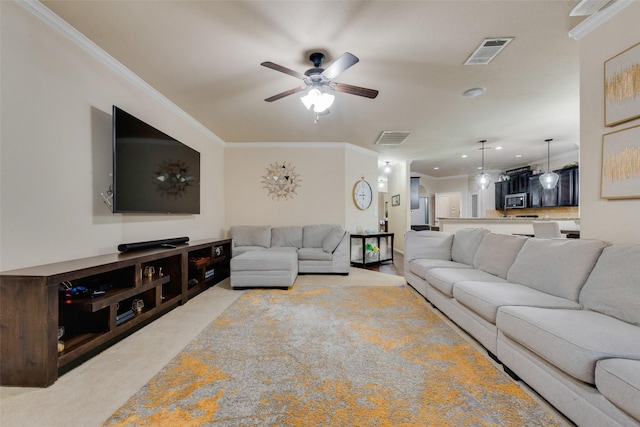 living room with ceiling fan, light colored carpet, and ornamental molding