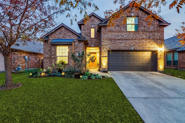 front facade featuring a garage and a yard