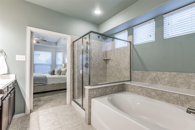 bathroom with tile patterned flooring, vanity, a wealth of natural light, and plus walk in shower