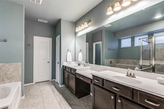 full bathroom featuring a sink, visible vents, a garden tub, and double vanity