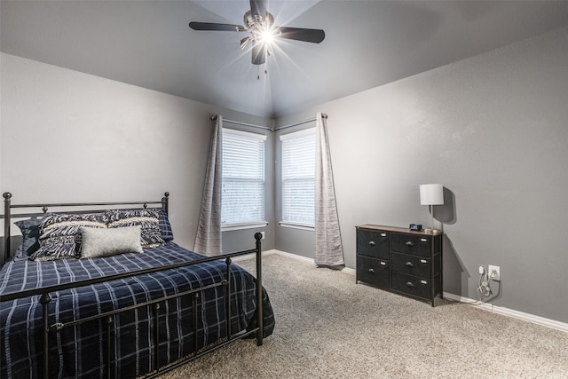 carpeted bedroom featuring lofted ceiling and ceiling fan