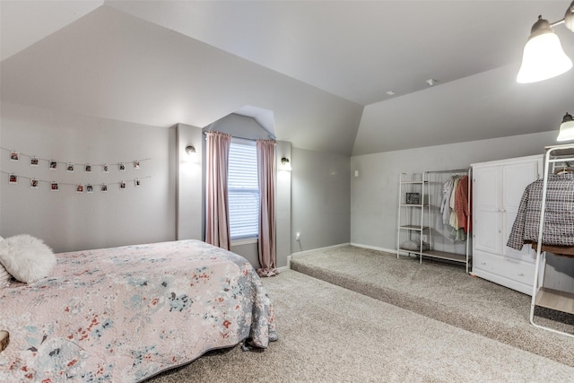 bedroom featuring baseboards, carpet, and vaulted ceiling