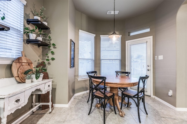 dining area featuring visible vents, baseboards, and light tile patterned flooring