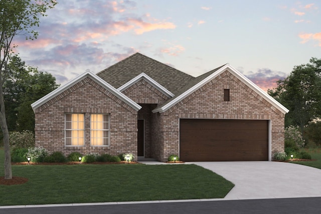 view of front facade with a yard and a garage