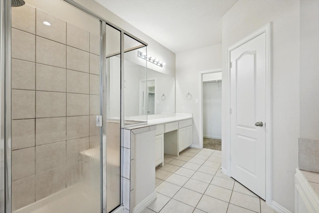 bathroom featuring vanity, an enclosed shower, and tile patterned flooring