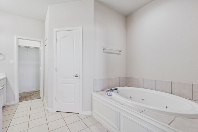 bathroom featuring tile patterned flooring, vanity, and a bathtub