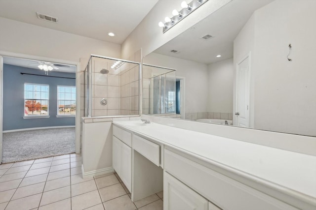 bathroom with tile patterned flooring, vanity, plus walk in shower, and ceiling fan