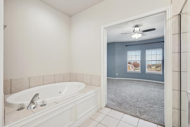 bathroom with ceiling fan, tile patterned floors, and a bath