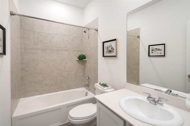 full bathroom featuring toilet, vanity, and tiled shower / bath