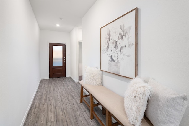 hallway with light hardwood / wood-style floors