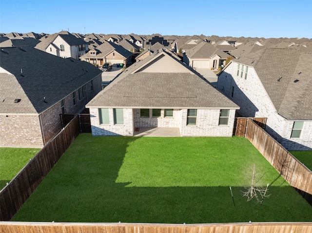 back of house with a yard and a patio