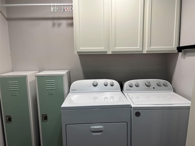 laundry room with cabinets and washer and dryer