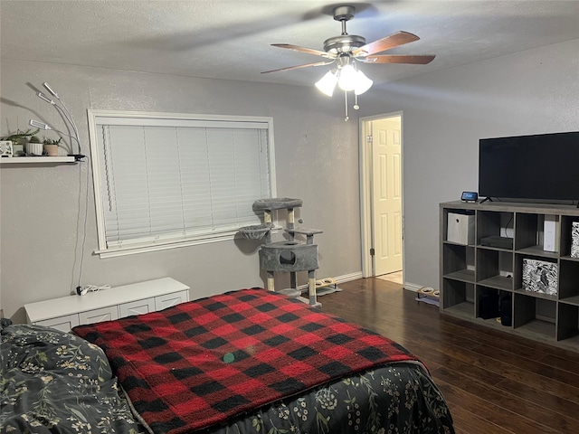 bedroom with ceiling fan and dark wood-type flooring