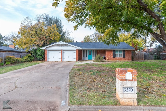 single story home with a garage and a front lawn