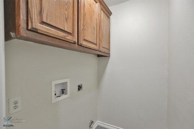 washroom featuring electric dryer hookup, hookup for a washing machine, and cabinets