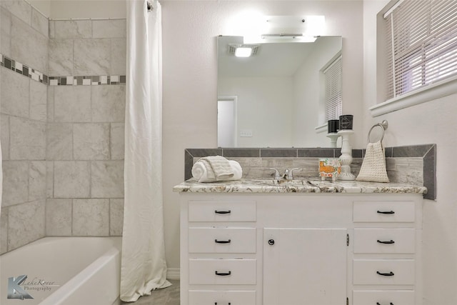 bathroom with shower / tub combo with curtain and vanity