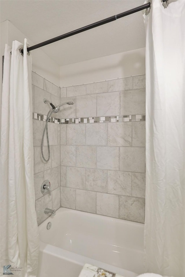 bathroom with shower / bath combination with curtain