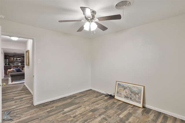 unfurnished room with dark hardwood / wood-style floors and ceiling fan