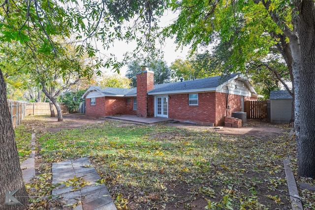 rear view of property with french doors and a patio