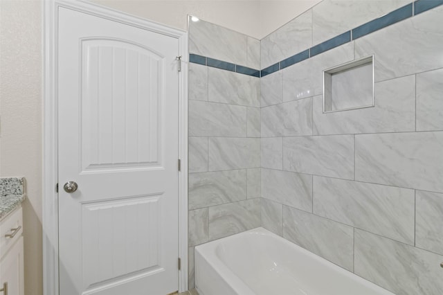 bathroom featuring vanity and tiled shower / bath combo