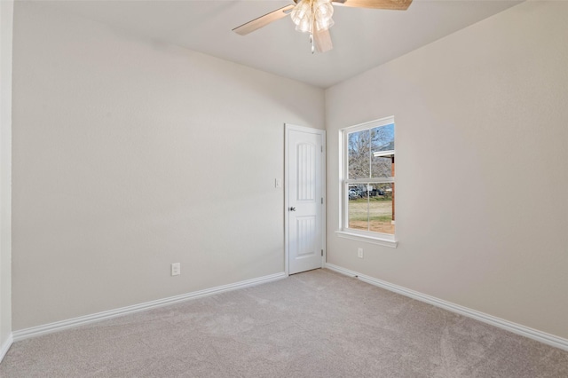 carpeted spare room with ceiling fan