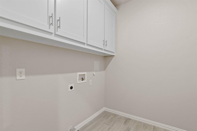 washroom featuring washer hookup, cabinets, light wood-type flooring, and hookup for an electric dryer