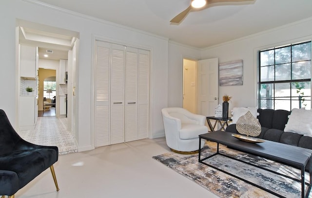 living room featuring ceiling fan and ornamental molding