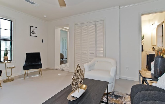 living area with crown molding