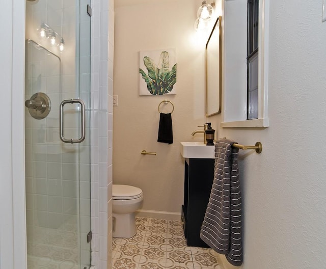 bathroom featuring tile patterned flooring, vanity, toilet, and walk in shower