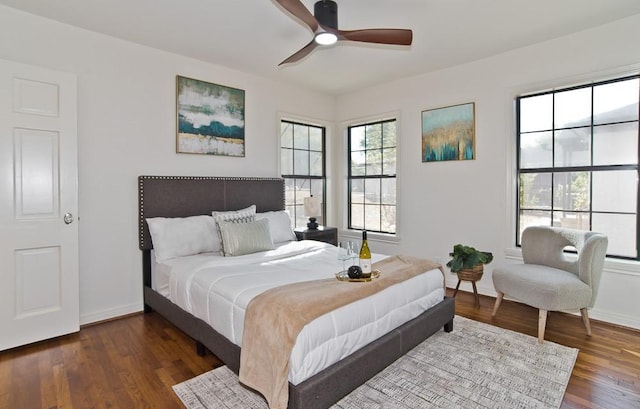 bedroom with dark hardwood / wood-style floors and ceiling fan