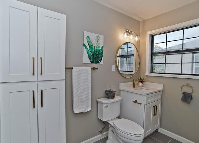 bathroom featuring tile patterned flooring, vanity, and toilet