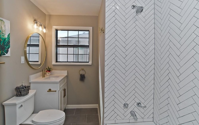 bathroom with tile patterned flooring, vanity, toilet, and walk in shower