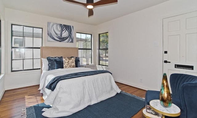 bedroom with ceiling fan and dark hardwood / wood-style flooring