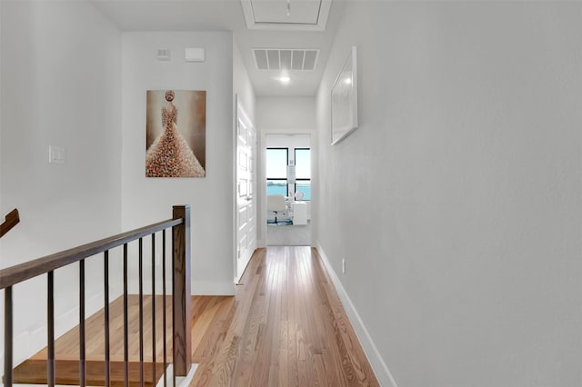 hallway with light hardwood / wood-style floors