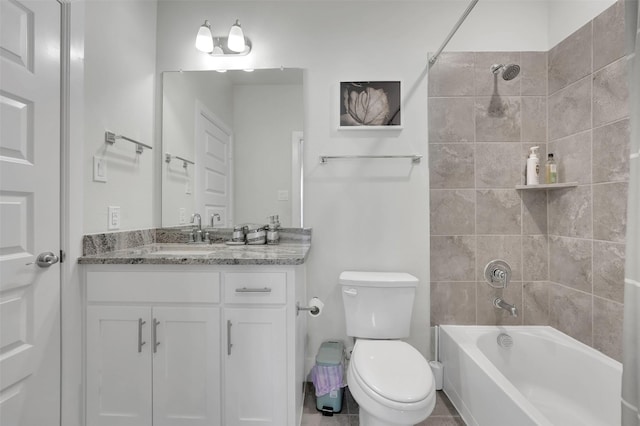 full bathroom with tile patterned flooring, vanity, toilet, and tiled shower / bath