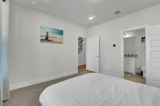 carpeted bedroom with connected bathroom