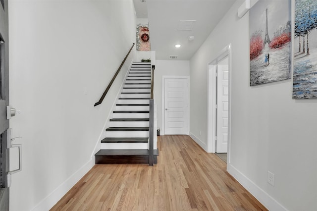 staircase with hardwood / wood-style flooring