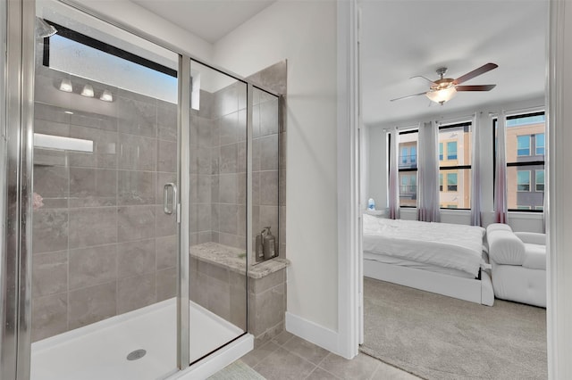 bathroom with tile patterned floors, a wealth of natural light, ceiling fan, and walk in shower