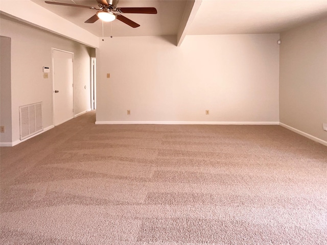 carpeted empty room with beam ceiling and ceiling fan