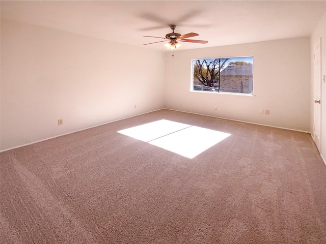 spare room featuring carpet floors and ceiling fan