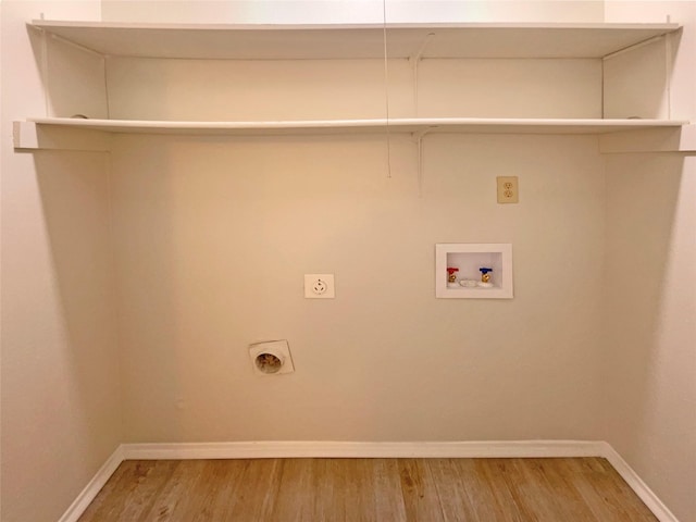 clothes washing area with hookup for an electric dryer, wood-type flooring, and washer hookup