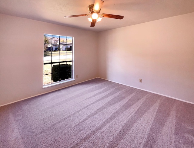 empty room with ceiling fan and carpet floors