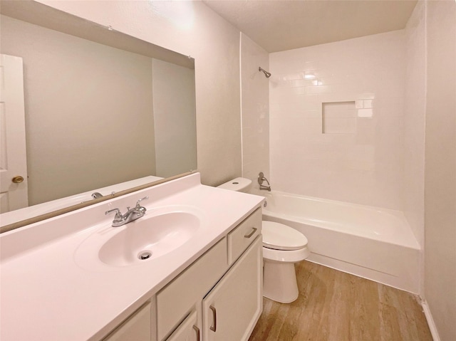 full bathroom with vanity, tiled shower / bath combo, hardwood / wood-style flooring, and toilet