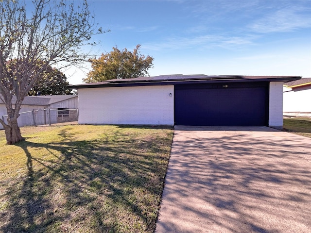 view of front of property with an outbuilding, a front lawn, and a garage