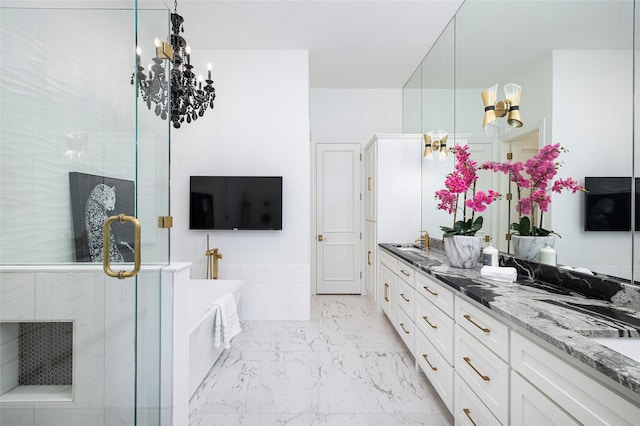 bathroom with an inviting chandelier, vanity, and shower with separate bathtub