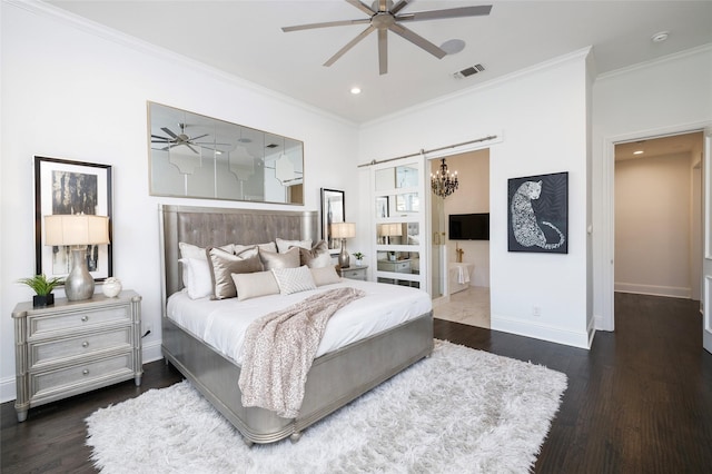 bedroom featuring dark wood-type flooring, ceiling fan, ornamental molding, and a barn door