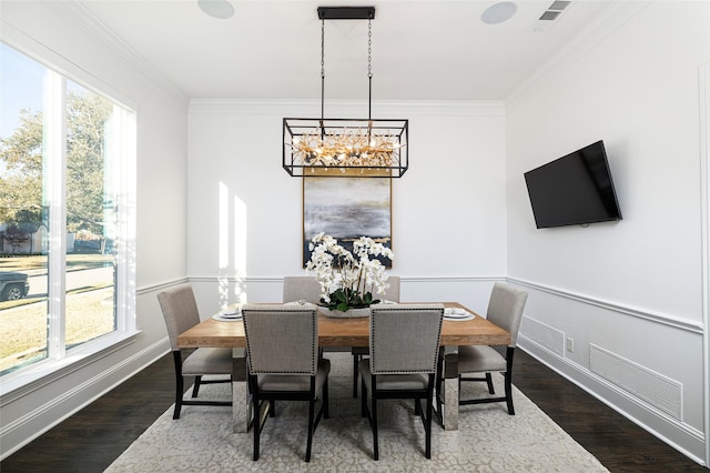 dining area with ornamental molding, dark hardwood / wood-style floors, and a chandelier