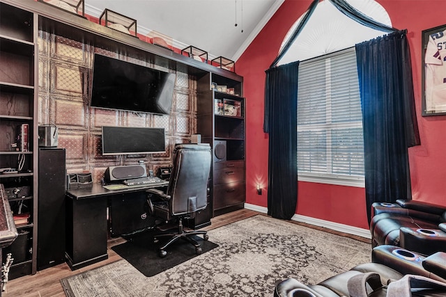 office area featuring crown molding, light hardwood / wood-style flooring, and vaulted ceiling